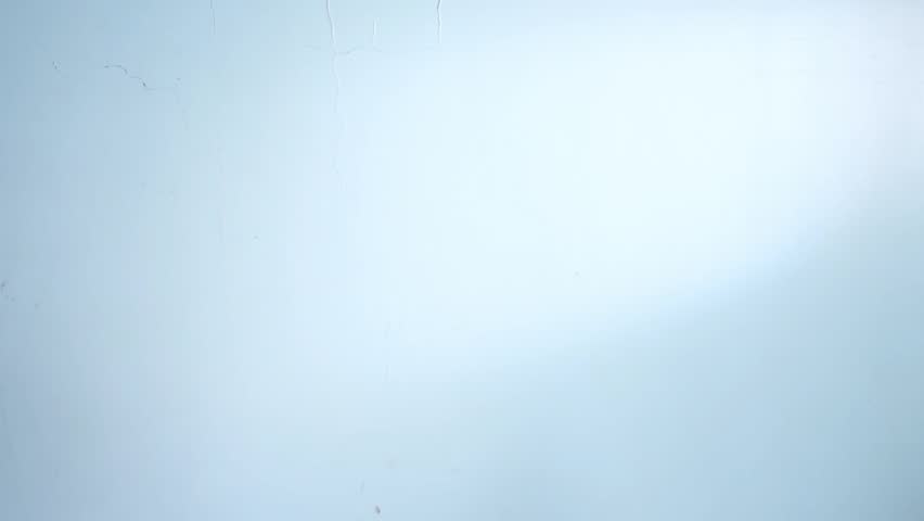 Vertical video of man wearing red jacket and vr headset on blue background 