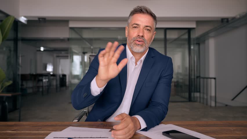 Middle-age Hispanic man using computer remote for business meeting, online virtual webinar training, video call with partners, clients. Smiling mature Latin businessman work in office, webcam view. Royalty-Free Stock Footage #1107618533