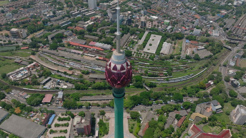 Detailed view of top of famous tall Lotus Tower high above city. Tilt up revealing cityscape. Colombo, Sri Lanka