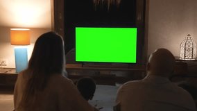 Happy Family of Parents with Young Kids Watching TV and Sitting on Sofa. People Inside at Home Watch News on Television Display Mockup. Children on Couch Looking at White Screen of Chroma Key Mock Up - Powered by Shutterstock - Get 15% off with code: PIKWIZARD15