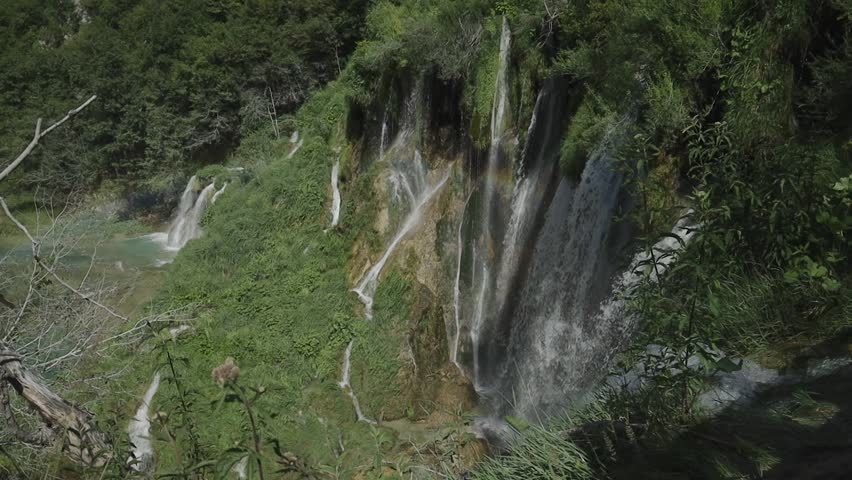 Panorama of Plitvice lakes in Croatia in summer. Wooden walkways over the crystal clear lakes transport us to an idyllic naturalistic landscape. An adventure between waterfalls, rivers and lakes.