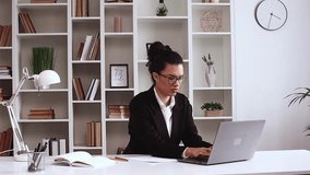A Latin American girl works at the computer and tries to win money, but she loses dollars. Loses an important contract. E commerce. Freelancer. Office, Formal wear, laptop.