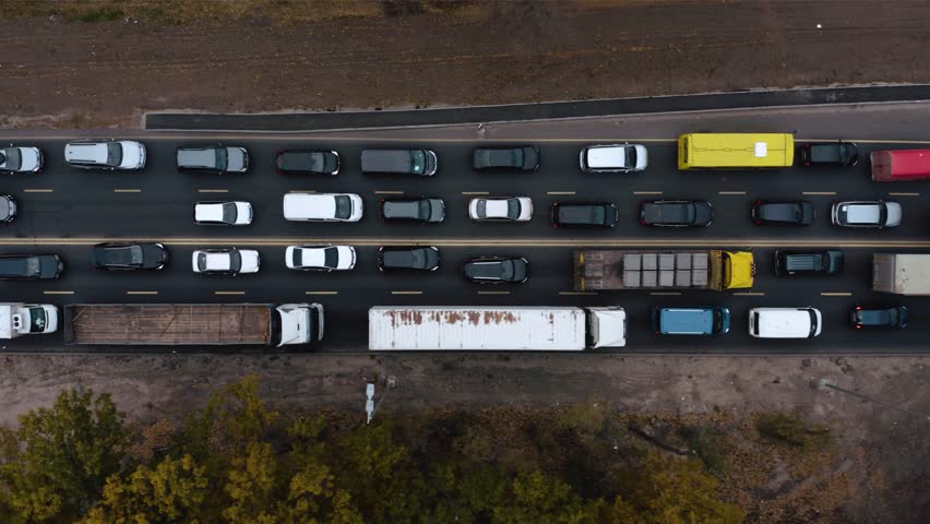 Aerial view. Traffic jam in a big city. Rush hour. Kiev, Ukraine. Car traffic jam. Aerial Drone Flight top down View of freeway busy city. Aerial vertical, vertical video background.  Royalty-Free Stock Footage #1107650583
