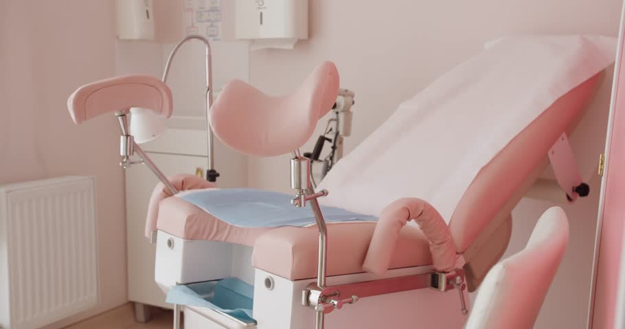 Gynecological chair in pink tones at private cabinet of hospital. Professional medic equipment for woman's examination or inspection. Health care concept Royalty-Free Stock Footage #1107661095