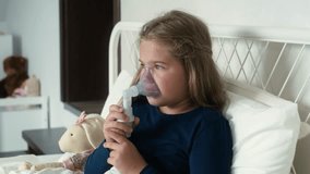 Elementary age girl  using nebulizer in bed at home. Shot with RED helium camera in 8K. 