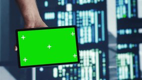 Vertical video Capable servicemen looking around high tech data center, using mockup laptop to crosscheck disaster recovery plan and assess servers cabinets in need of replacement, preventing troubles - Powered by Shutterstock - Get 15% off with code: PIKWIZARD15