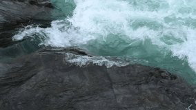 Clear stream running through stone boulders in Sweden. Abundant river flowing on large stones. Wild mountain river water splashing in summer day. Slow motion. - Powered by Shutterstock - Get 15% off with code: PIKWIZARD15