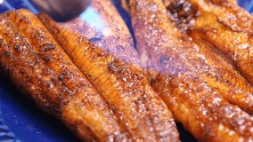 Grilled eel. A video that is burning with a cooking torch.
