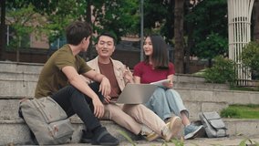 Long shot of group of students meeting outdoors while preparing for school project with laptop - Powered by Shutterstock - Get 15% off with code: PIKWIZARD15
