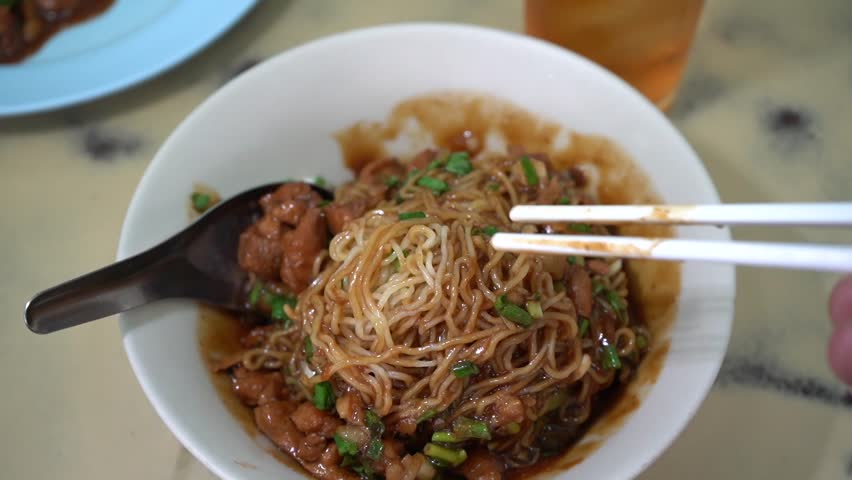 boiled yellow noodle process in big pot at local noodle restaurant street food in Thailand. 