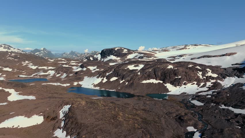 Nordic Wilderness Majesty: Aerial Vista of Snow-Capped Mountain Range in Jotunheimen, Norway