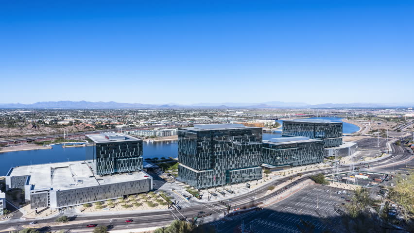 A day to night transition time lapse of Phoenix shot from atop Tempe Butte Mountain shows the city light up in magnificent colors and planes coming in to land at Phoenix Sky Harbor.