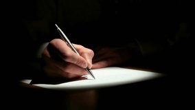 men hand in the dark with writing letter on paper with lights on it. learn and study concept - Powered by Shutterstock - Get 15% off with code: PIKWIZARD15