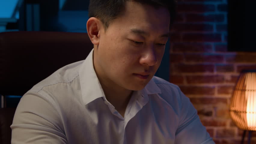 Exhausted fatigued tired Asian man manager office worker at night evening overworked deadline job project working with boring laptop startup sleepy businessman Korean employer drowsy boredom stressed Royalty-Free Stock Footage #1107681955