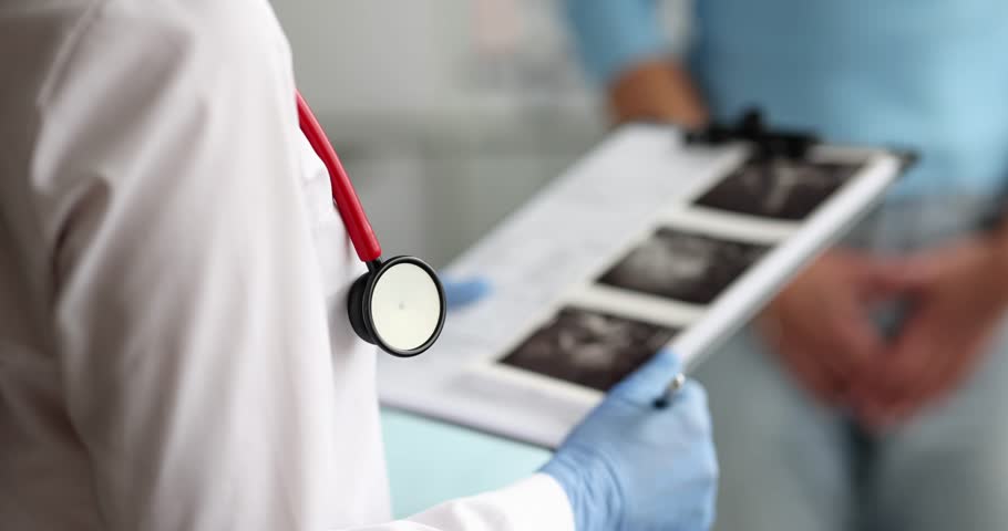 Uterus and ovary doctor holding ultrasound picture for diagnosis and treatment in hospital Royalty-Free Stock Footage #1107683141