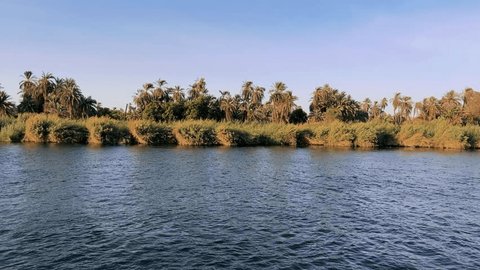 Discover the rich tapestry of history as you leisurely sail the Nile River aboard a comfortable cruise ship. This journey unveils Egypt's cultural treasures. Nile River Cruise: Sailing the Waters of Stockvideó
