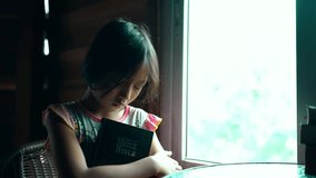 Child girl hugging the bible and praying with faith, christian concept. High quality 4k video.