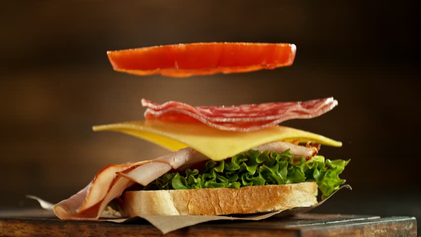 Super slow motion of stacking sandwich pieces. Camera in motion. Filmed on high speed cinema camera, 1000 fps. Placed on high speed cine bot. Speed ramp effect.