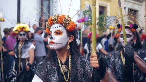 Oaxaca, Mexico - November 02, 2022: Dancers with Mexico Catrina makeup in the parade before Day of death. Is an annual indigenous cultural event with traditional dancing and costume Editorial Stock Video
