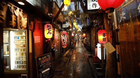 Tokyo, Japan - June 2, 2023: Omoide Yokocho on a rainy night in Tokyo's Shinjuku district. Toimituksellinen arkistovideo
