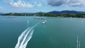 Flight over the sea in Phuket, drone view of the transport pier in Ao Po Bay