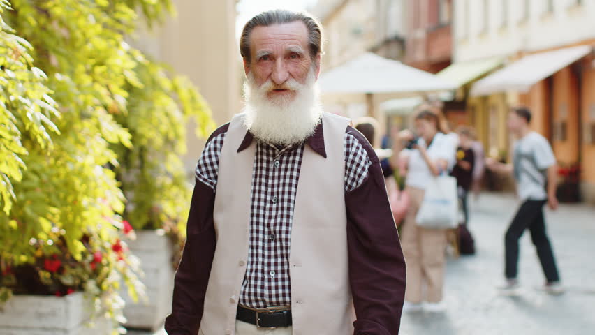 Like. Happy bearded senior old man looking approvingly at camera showing thumbs up sign positive something good positive feedback. Elderly mature grandfather standing in urban city sunshine street | Shutterstock HD Video #1107706759