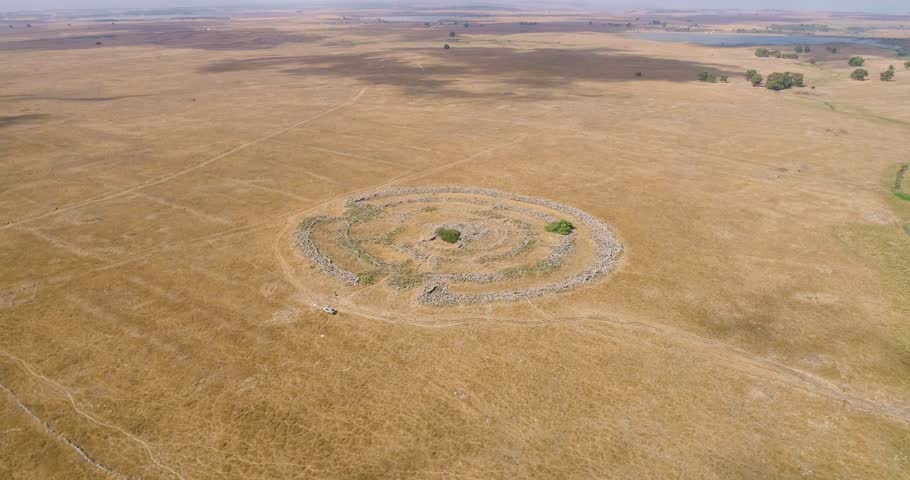Aerial view of ancient megalithic monument site in the shape of 3 concentric stone circles, Rujum Al-Hiri, Golan Heights, Israel.
