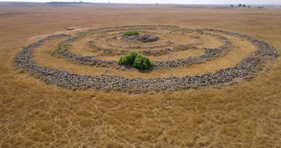 Aerial view of ancient megalithic monument site in the shape of 3 concentric stone circles, Rujum Al-Hiri, Golan Heights, Israel.