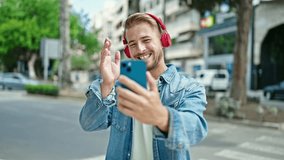 Young caucasian man smiling confident having video call at street