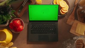 Top View of Anonymous WomanTyping on a Laptop with Mock Up Green Screen Chromakey Display with Motion Tracker Placeholders. Female Business Owner Shopping Online for Ingredients for her Restaurant - Powered by Shutterstock - Get 15% off with code: PIKWIZARD15