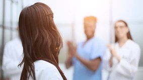 Successful team of different doctors clapping hands - Powered by Shutterstock - Get 15% off with code: PIKWIZARD15