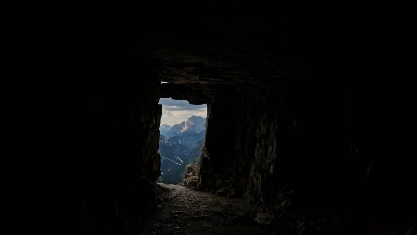 Woman with backpack hiking secret cave of Tre Cime di Lavaredo Dolomites mountain view. Summer adventure journey in nature outdoors. Travel exploring Alps, Dolomites, Italy Royalty-Free Stock Footage #1107716231