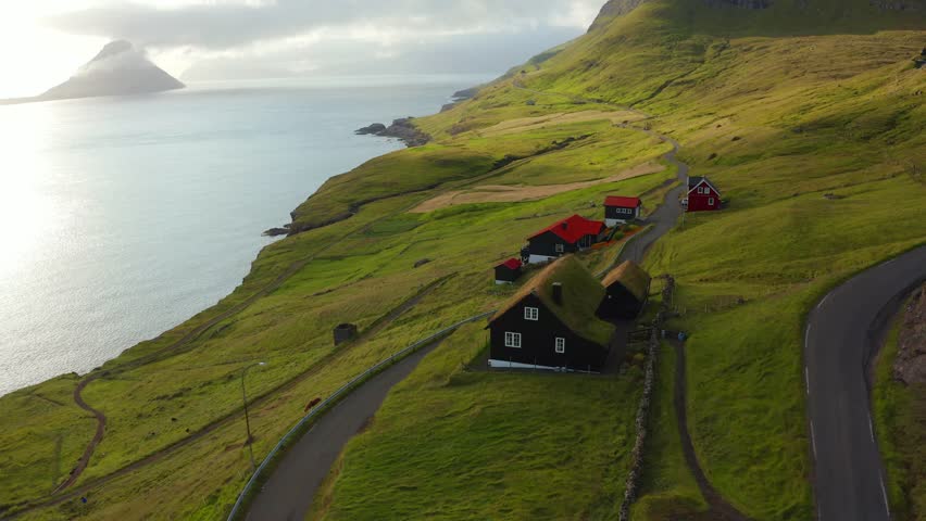 4k drone forward video (Ultra High Definition) of Velbastadur village with typical turf-top houses. Gloomy morning scene of Streymoy island, Faroe, Denmark, Europe. Traveling concept background. Royalty-Free Stock Footage #1107716347