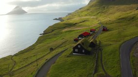 4k drone forward video (Ultra High Definition) of Velbastadur village with typical turf-top houses. Gloomy morning scene of Streymoy island, Faroe, Denmark, Europe. Traveling concept background.