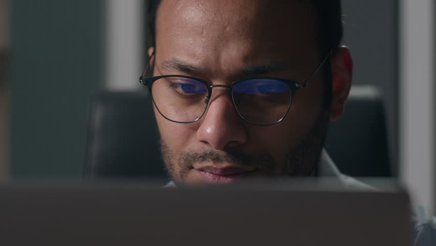 Close up pensive thoughtful male office worker reading bad news in laptop think concerned Indian man American businessman thinking problem solution worry anxiety difficulties business data failure Royalty-Free Stock Footage #1107717251