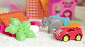 Cleaning in the children's room. Collect children's toys, close-up. Large design details. Toys for small children - Powered by Shutterstock - Get 15% off with code: PIKWIZARD15