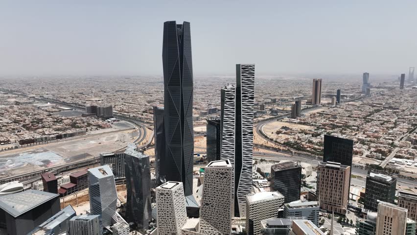 The drone is flying towards the skyscrapers of the King Abdullah Financial District to the top in Riyad Saudi Arabia Aerial Footage 4K Royalty-Free Stock Footage #1107724405
