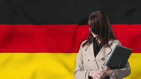 Stylish girl holds a laptop in her hands with waving flag of Germany in background. 3d animation in 4k resolution video.