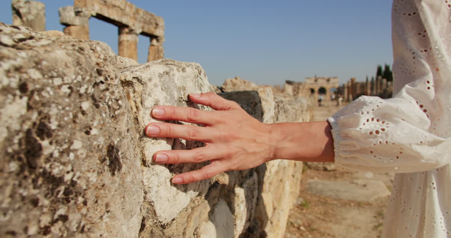 Woman hand touch of ruin ruins in ancient greek city Hierapolis in Pamukkale, close-up shot Royalty-Free Stock Footage #1107729171