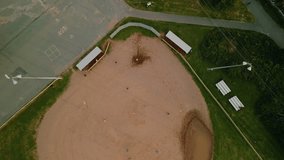 Cinematic drone shot on baseball field with players. Male and female baseball players in action during a game in a baseball stadium. Baseball field with players in uniform playing the game. - Powered by Shutterstock - Get 15% off with code: PIKWIZARD15