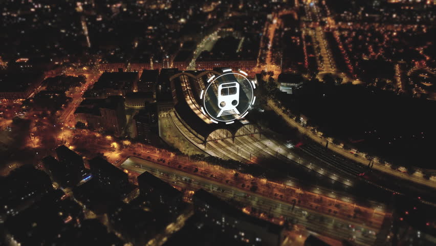 Evening high angle view of traffic on thoroughfare and Estacion de Francia train station. Visual effects representing arriving and leaving trains. Barcelona, Spain