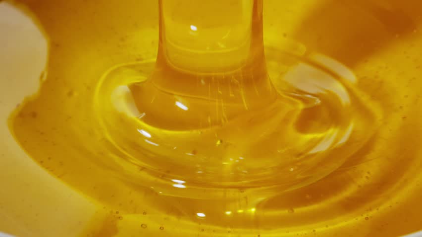 Liquid Gold. Pouring Honey in Motion Royalty-Free Stock Footage #1107731363