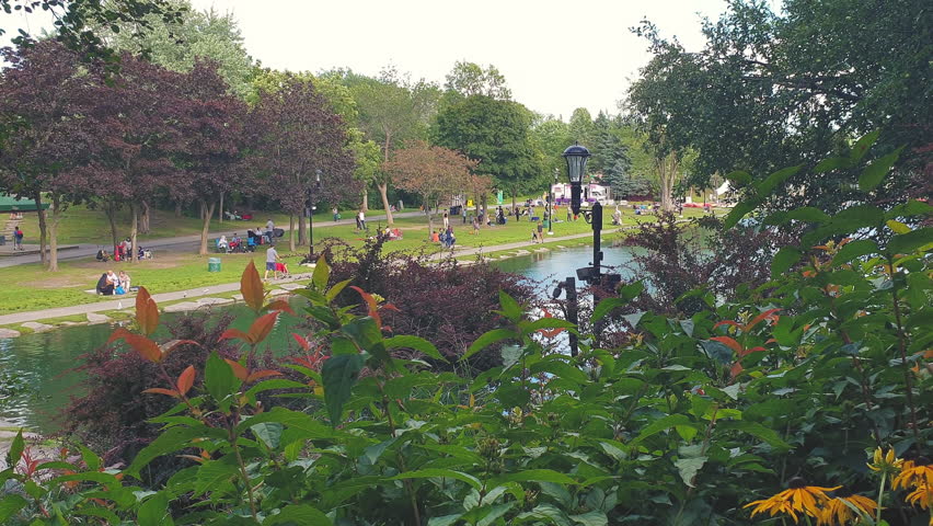 Water Lake View on a Beautful Parc,with Kids Sitting and Playing around the Water,4K