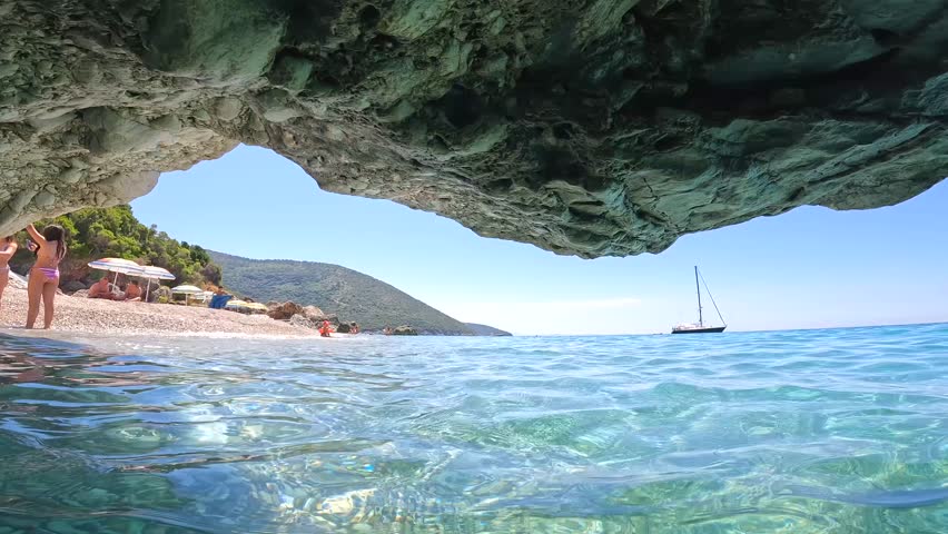 Water shot from a small boat cave on the beach of Kroreza or Krorez on the Albanian riviera in Sarande, Albania. With aquatic action chamber Royalty-Free Stock Footage #1107753197