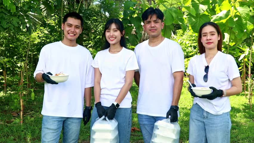 Asian group doing social volunteer work donating food, rice, fried eggs and food in boxes. willing to help society giving food to rescue volunteers who participated in forest planting activities. Royalty-Free Stock Footage #1107756271