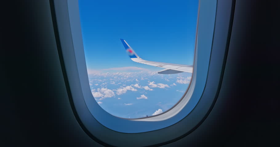 Looking out of an airplane window in the sky Royalty-Free Stock Footage #1107763527