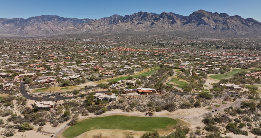 Tucson Arizona Aerial v5 flyover Oro Valley Canada Hills neighborhoods capturing spectacular mountainscape, El Conquistador Golf course and tennis courts - Shot with Mavic 3 Cine - March 2022