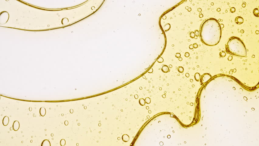Transparent cosmetic gel fluid with molecule bubbles oil distribution. Bubble cluster, cells under a microscope. Macro Shot of Natural Organic Cosmetics, Medicine. Production Close-up. Slow Motion. Royalty-Free Stock Footage #1107775727