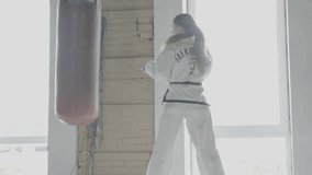 Slow motion Taekwondo Girl Trains With Punching Bag In The Gym - Powered by Shutterstock - Get 15% off with code: PIKWIZARD15