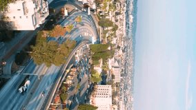 Busy traffic on multilevel roads, bridges, ramps, viaducts at sunset, Los Angeles California. Above the highway in Los Angeles. Aerial vertical, vertical video background.